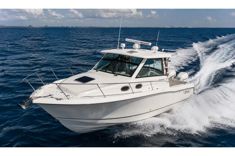 The Image of 2018 Boston Whaler 315 Conquest cruising on open ocean waters. - 0