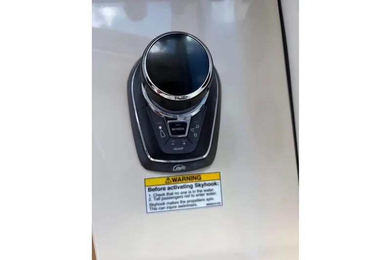 Slide: The Image of Control panel of 2018 Boston Whaler 315 Conquest boat with Skyhook feature warning. - 10