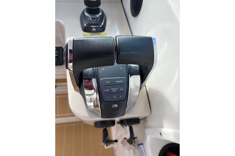 Slide: The Image of Throttle controls on a 2018 Boston Whaler 315 Conquest boat dashboard. - 12