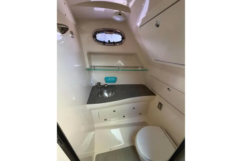 Slide: The Image of 2018 Boston Whaler 315 Conquest boat bathroom with sink, toilet, and storage. - 14