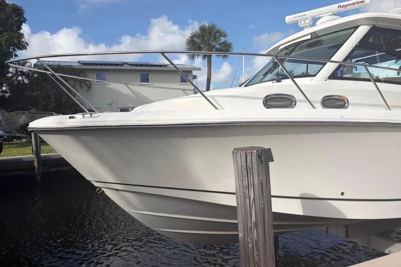Slide: The Image of 2018 Boston Whaler 315 Conquest boat docked, showcasing sleek design and modern features. - 3