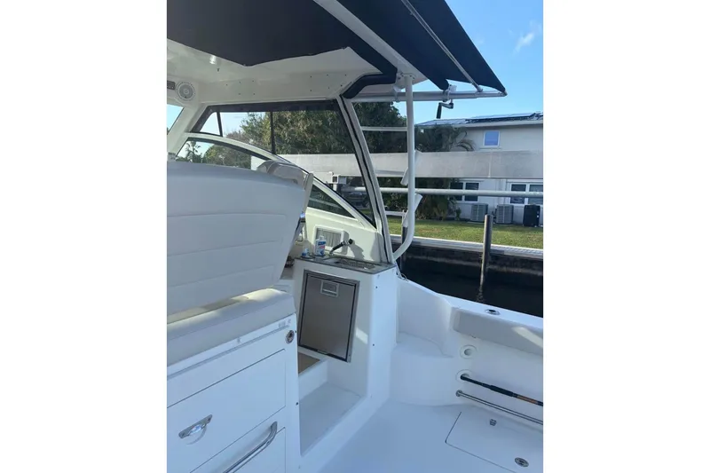 Slide: The Image of 2018 Boston Whaler 315 Conquest interior with helm and seating area. - 4