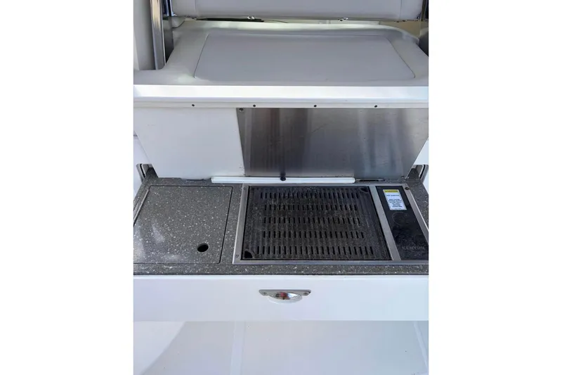 Slide: The Image of 2018 Boston Whaler 315 Conquest boat grill and countertop detail. - 7