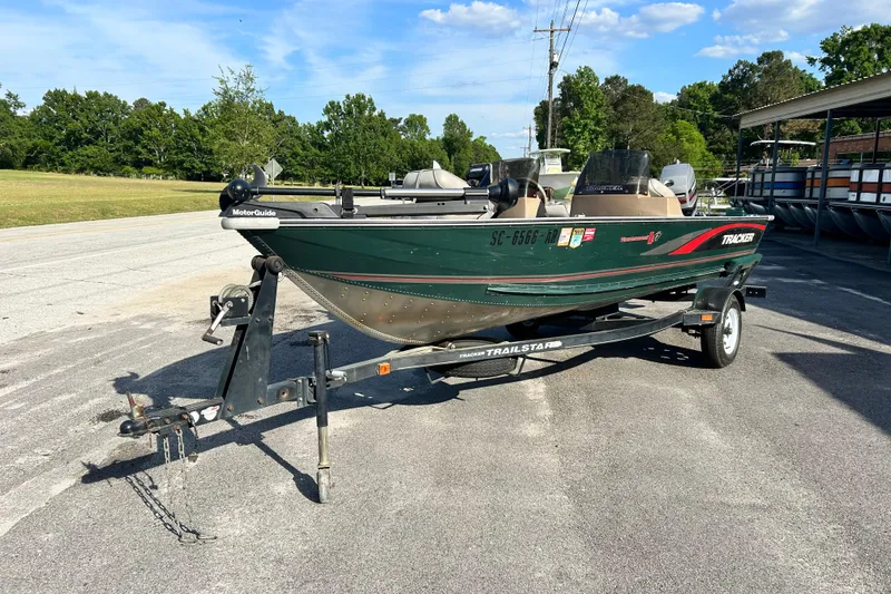 Slide: The Image of 1996 Tracker Tournament V-17 boat on trailer in outdoor setting. - 2