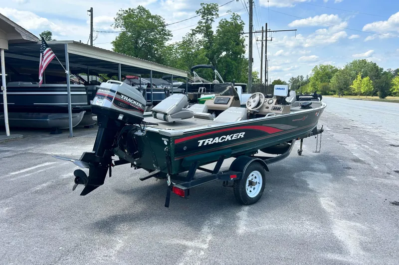 Slide: The Image of 1996 Tracker Tournament V-17 boat on trailer, parked outdoors under a clear sky. - 3