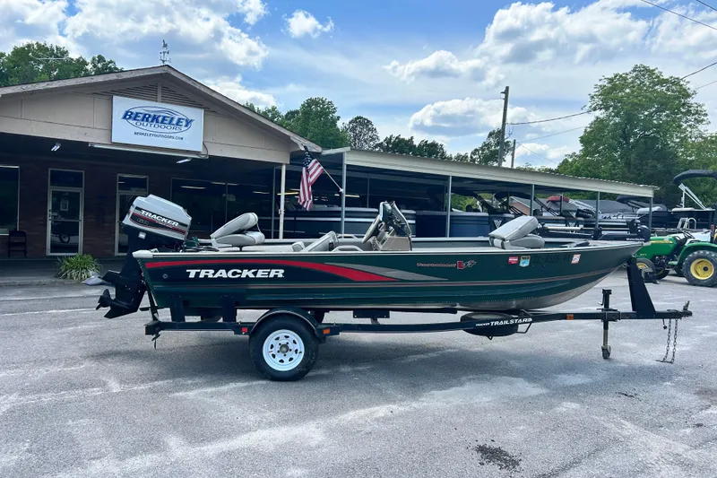 Slide: The Image of 1996 Tracker Tournament V-17 boat on trailer outside Berkeley Outdoors store. - 4