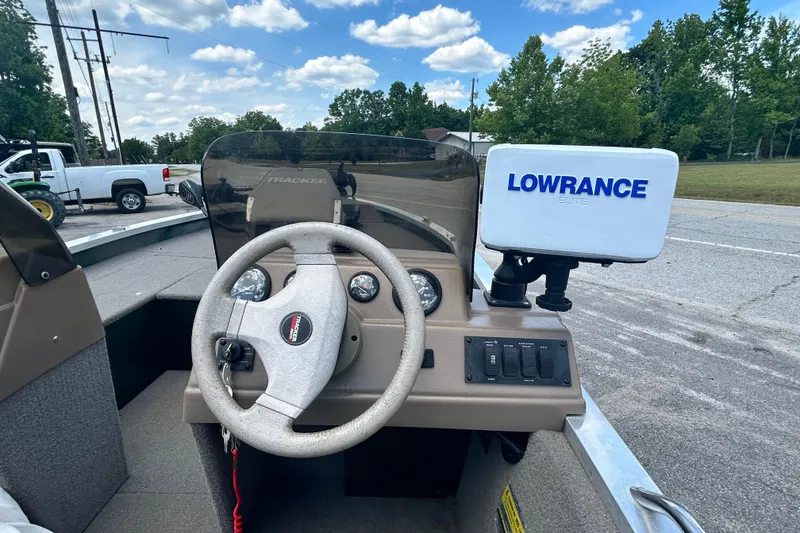 Slide: The Image of 1996 Tracker Tournament V-17 boat dashboard with steering wheel and Lowrance Elite fish finder. - 8