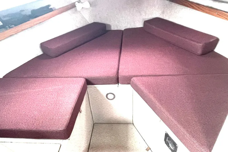Slide: The Image of Interior of a 2005 Lifetimer 3540 boat with maroon cushions in the cabin. - 10