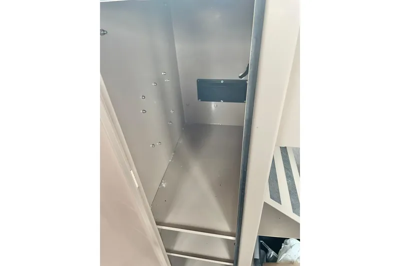 Slide: The Image of Empty interior of Lifetimer 3540 model, 2005, showing metal compartment with mounting holes. - 14
