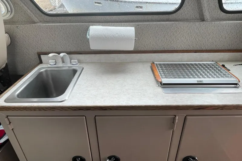 Slide: The Image of Compact kitchen area in a 2005 Lifetimer 3540 boat with sink and stove. - 15