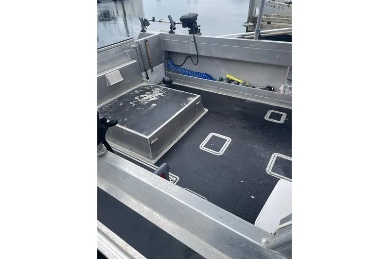 Slide: The Image of Open deck of a 2005 Lifetimer 3540 boat with storage compartments. - 17