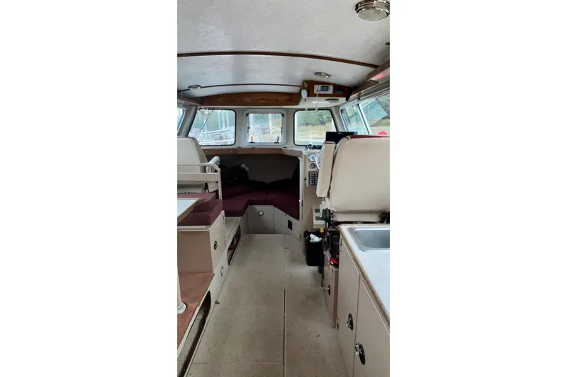 Slide: The Image of Interior of a 2005 Lifetimer 3540 boat, featuring seating and navigation area. - 2