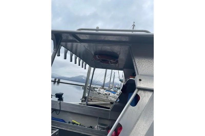 Slide: The Image of Aluminum boat with rod holders, Lifetimer 3540, docked by snowy mountains, 2005 model. - 20