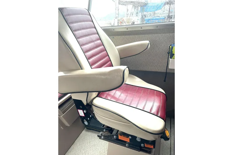 Slide: The Image of Captain's chair in a Lifetimer 3540 boat, 2005 model, with maroon and beige upholstery. - 3
