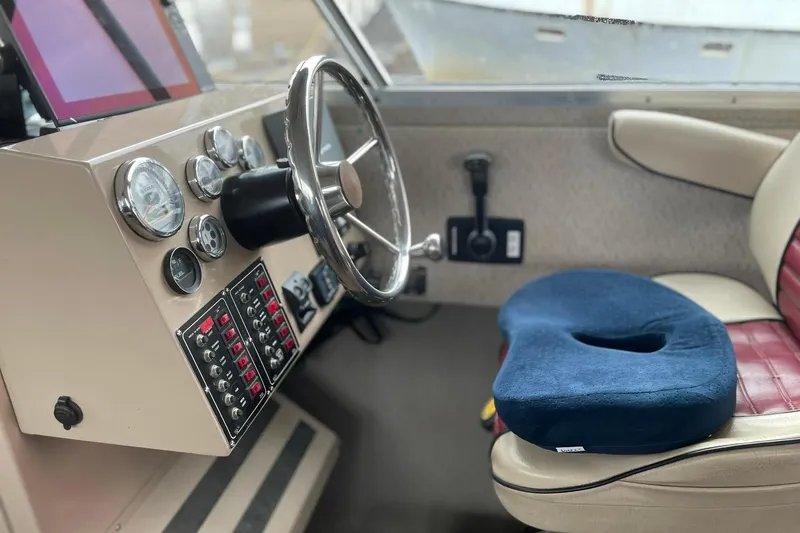 Slide: The Image of Boat cockpit with steering wheel, control panel, and blue cushion on seat, Lifetimer 3540, 2005 model. - 4
