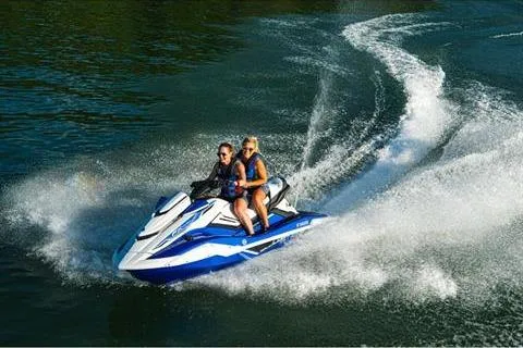 Slide: The Image of 2021 Yamaha WaveRunner FX Cruiser HO speeding on water with two riders. - 10