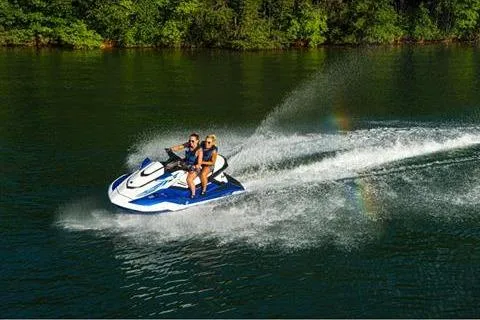 Slide: The Image of 2021 Yamaha WaveRunner FX Cruiser HO speeding on a lake with two riders. - 11