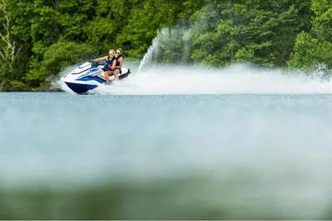 Slide: The Image of 2021 Yamaha WaveRunner FX Cruiser HO speeding on a lake with lush green trees. - 14