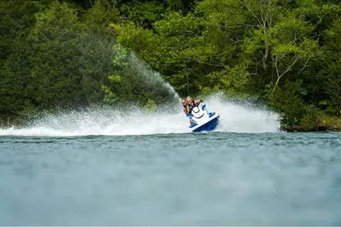 Slide: The Image of 2021 Yamaha WaveRunner FX Cruiser HO speeding on a lake with lush green trees. - 17