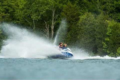 Slide: The Image of 2021 Yamaha WaveRunner FX Cruiser HO speeding on a lake with lush green forest backdrop. - 18
