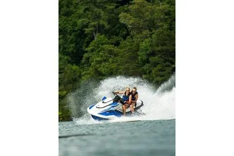 Slide: The Image of 2021 Yamaha WaveRunner FX Cruiser HO speeding on a lake with lush green forest backdrop. - 19