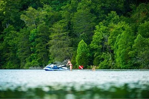 Slide: The Image of 2021 Yamaha WaveRunner FX Cruiser HO on a serene lake with lush green forest backdrop. - 20