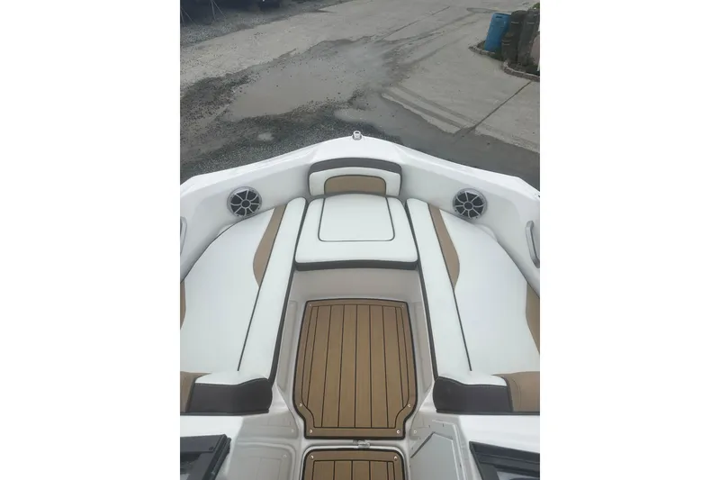 Slide: The Image of 2021 Yamaha Boats 195S interior with white and tan seating, featuring marine speakers. - 14