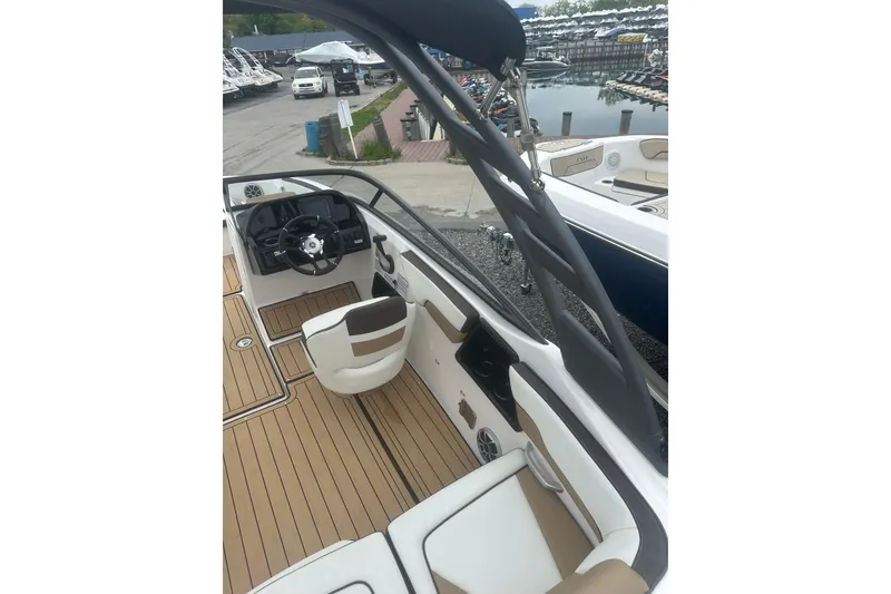 Slide: The Image of 2021 Yamaha Boats 195S interior with sleek design and modern steering console. - 21