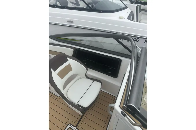 Slide: The Image of 2021 Yamaha Boats 195S interior with white and brown seating, sleek design. - 24