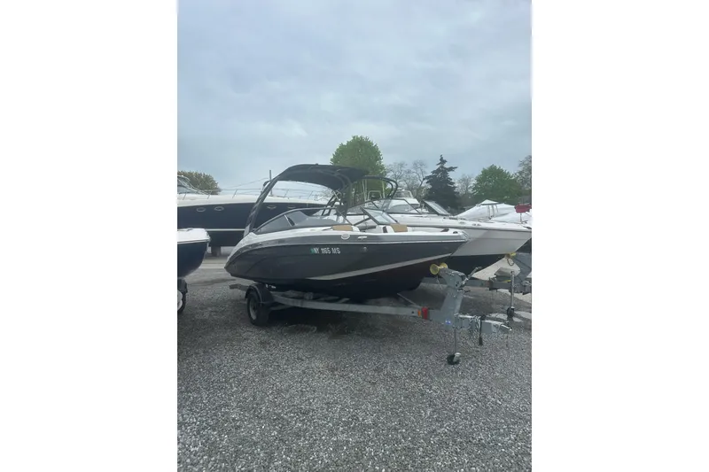 Slide: The Image of 2021 Yamaha Boats 195S on trailer, parked outdoors on gravel. - 3