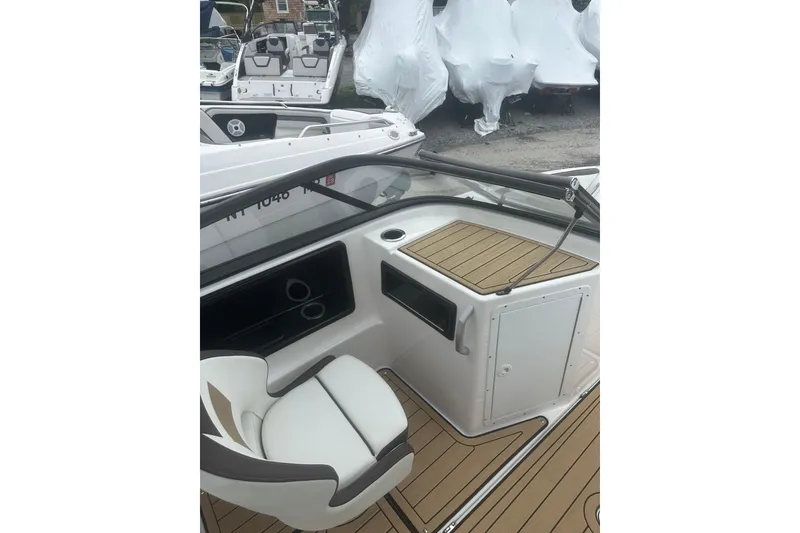 Slide: The Image of 2021 Yamaha Boats 195S interior with sleek seating and wood accents. - 9