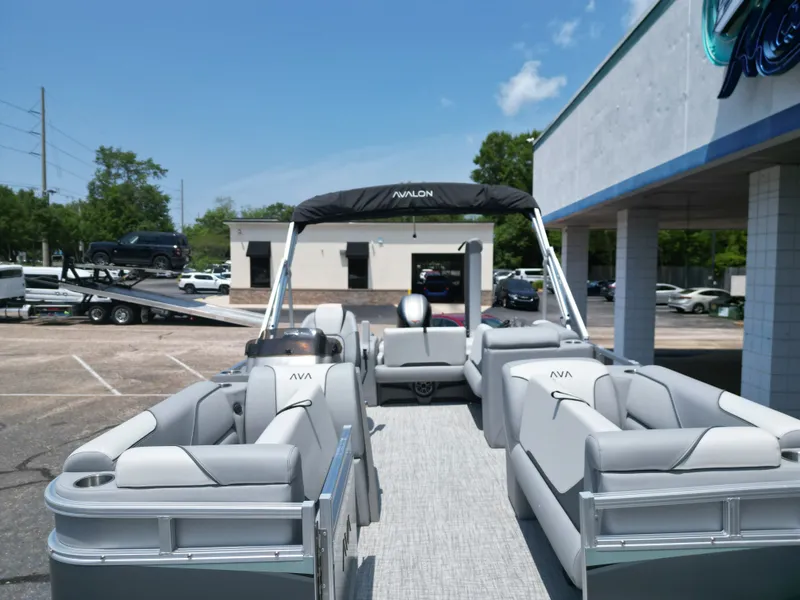 Slide: The Image of 2026 Avalon VNT VRB21 pontoon boat parked under sunny skies. - 10