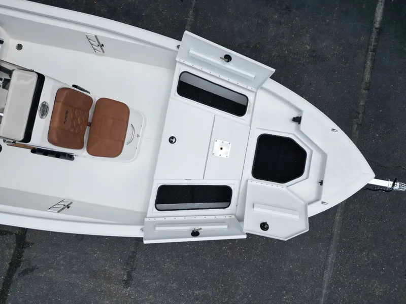 Slide: The Image of Aerial view of 2026 Avid 19 FSX boat with open storage compartments. - 13