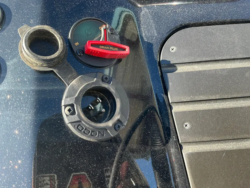 Slide: The Image of Close-up of Ranger Z520R 2024 boat dashboard with drain plug. - 13