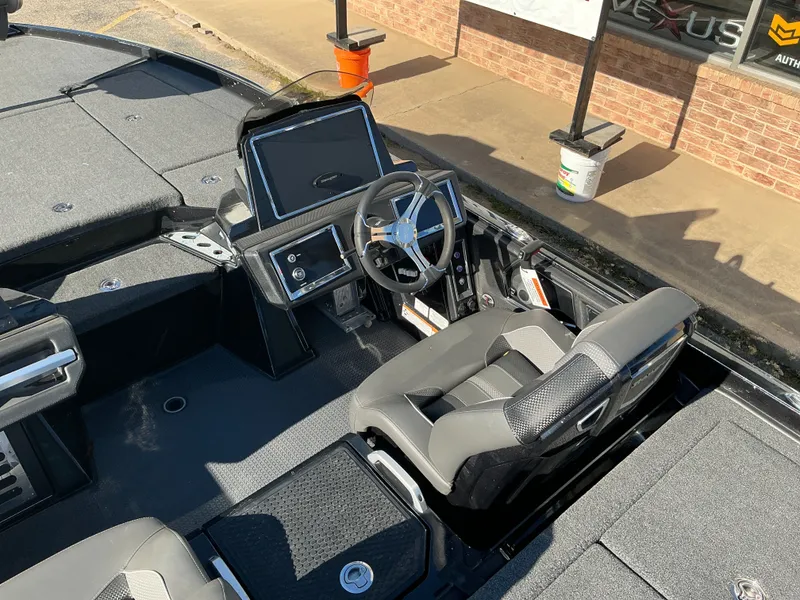 Slide: The Image of Interior of a 2024 Ranger Z520R boat with modern steering console. - 25