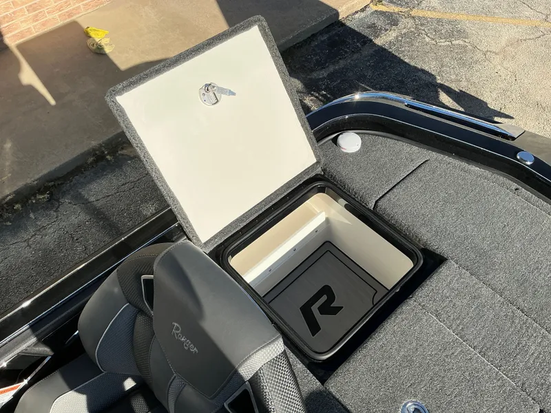 Slide: The Image of 2024 Ranger Z520R boat with open storage compartment and seat. - 42