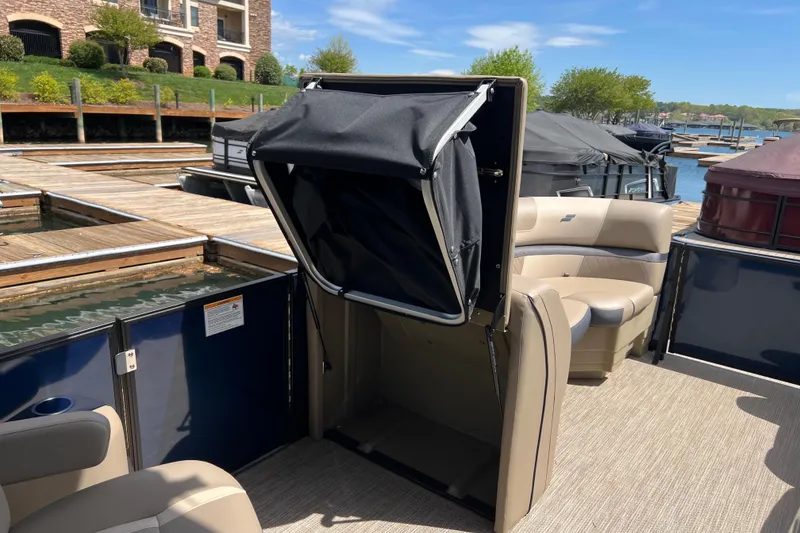 Slide: The Image of 2026 Starcraft EXS 3 R DH pontoon boat with seating and storage, docked at marina. - 10