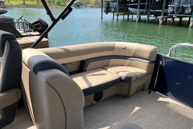 Slide: The Image of 2026 Starcraft EXS 3 R DH boat interior with beige seating by a lake. - 12