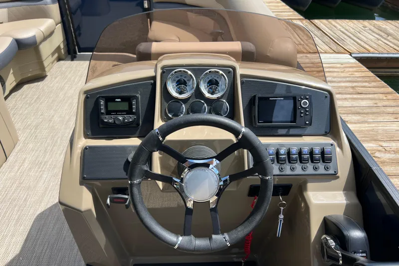 Slide: The Image of 2026 Starcraft EXS 3 R DH boat dashboard with steering wheel, gauges, and controls. - 14