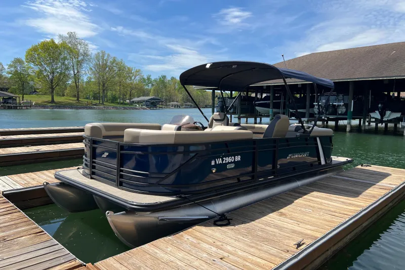 Slide: The Image of 2026 Starcraft EXS 3 R DH pontoon boat docked on a sunny lake. - 3