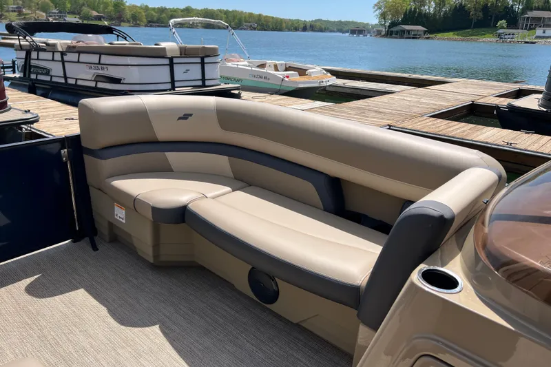 Slide: The Image of Luxurious seating on a 2026 Starcraft EXS 3 R DH pontoon boat at a scenic dock. - 6