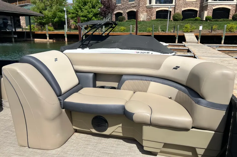 Slide: The Image of Luxurious seating on a 2026 Starcraft EXS 3 R DH boat, docked by waterfront homes. - 7