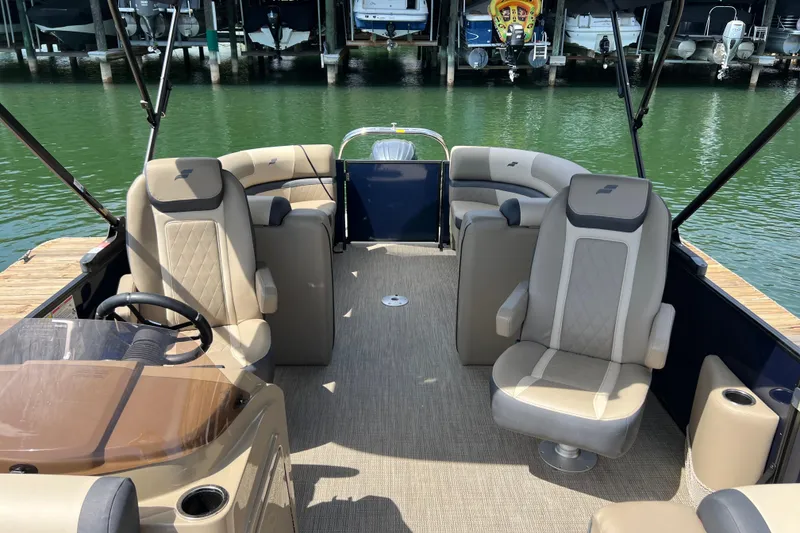 Slide: The Image of Interior of 2026 Starcraft EXS 3 R DH boat with beige seating and steering wheel. - 8