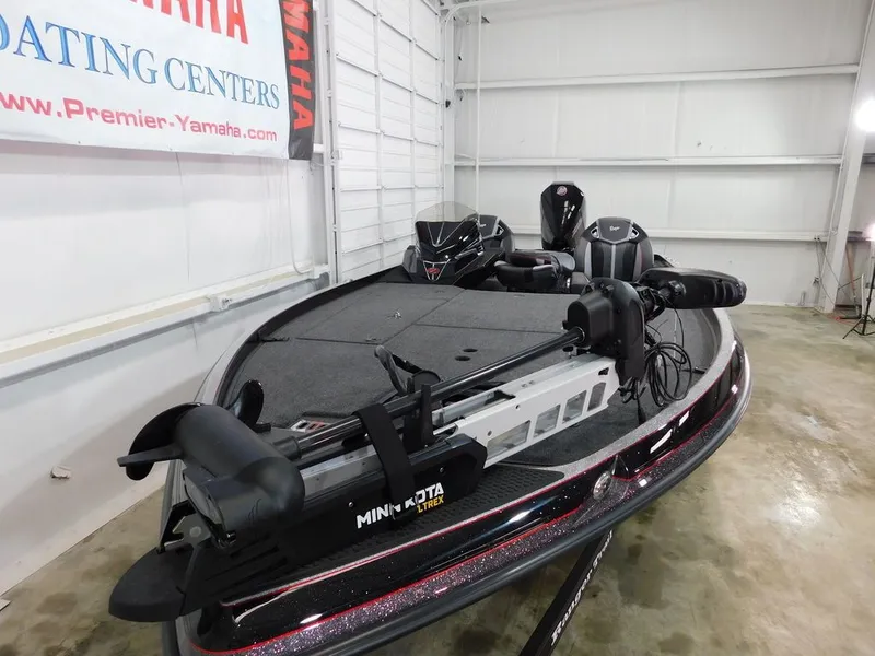 Slide: The Image of 2024 Ranger Z521R boat with Minn Kota trolling motor in a showroom. - 8
