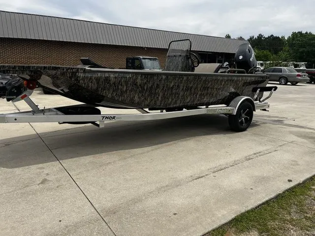 Slide: The Image of 2026 Thor LH1900CC boat with Mossy Oak design on trailer. - 27