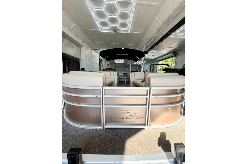 Slide: The Image of 2011 Bennington 2275RLi pontoon boat in a garage with modern lighting. - 10