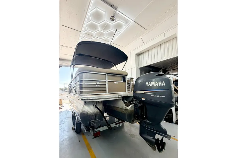Slide: The Image of 2011 Bennington 2275RLi pontoon boat with Yamaha outboard motor in a garage. - 12