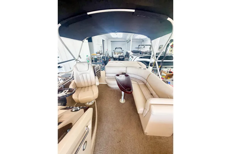 Slide: The Image of Interior of 2011 Bennington 2275RLi pontoon boat with beige seating and canopy. - 14