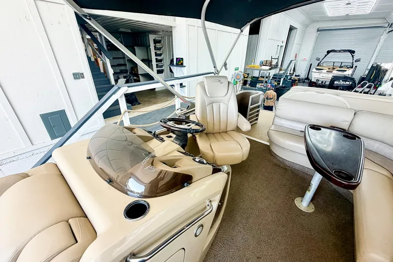 Slide: The Image of Interior of a 2011 Bennington 2275RLi pontoon boat with beige seating and helm. - 5