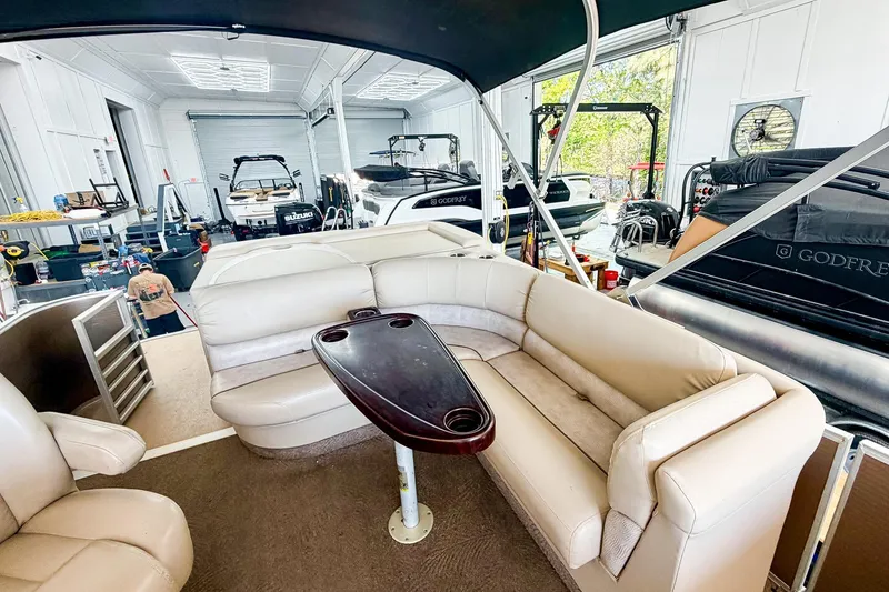 Slide: The Image of Interior of a 2011 Bennington 2275RLi pontoon boat in a garage setting. - 7